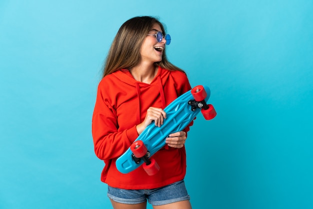 Young woman with a blue skateboard