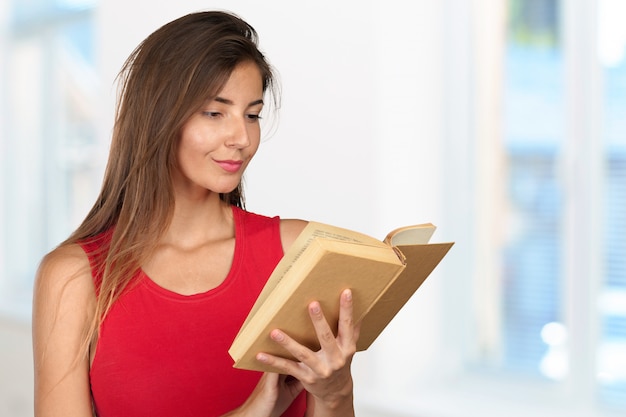 Young woman with a books pile