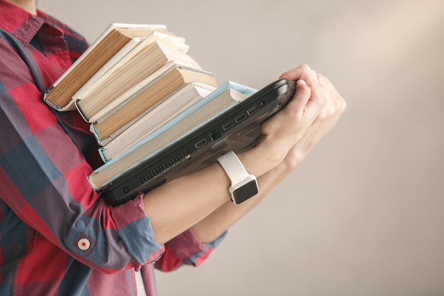 Young woman with books studio portrait education