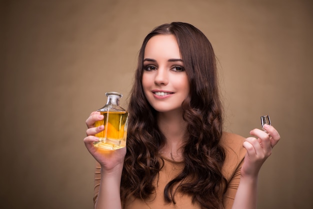 Young woman with bottle of perfume