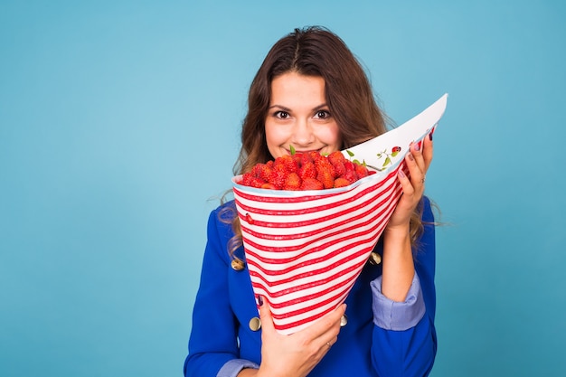 Young woman with a bouquet of strawberry