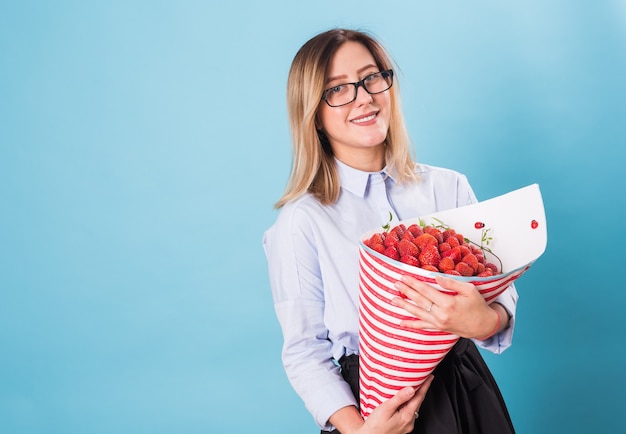 Young woman with a bouquet of strawberry