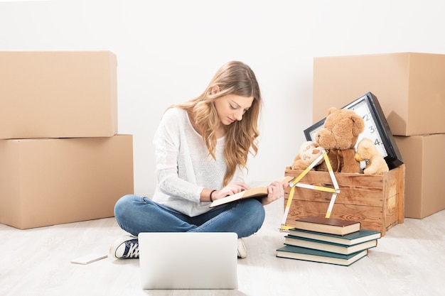 Young woman with boxes just moving into her new home