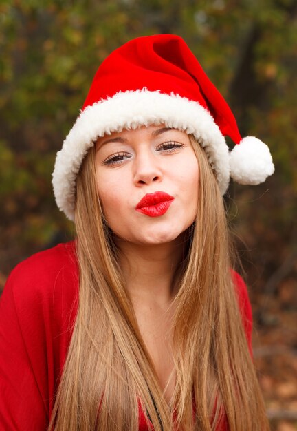 Young woman with Christmas hat in the forest