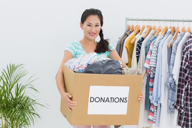 Young woman with clothes donation