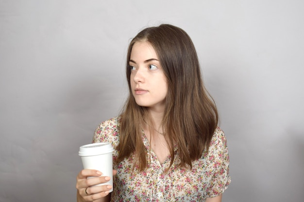 Young woman with coffee in her hands