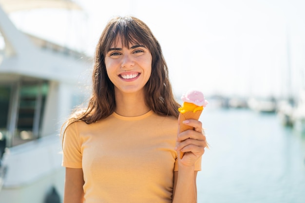 Young woman with a cornet ice cream at outdoors