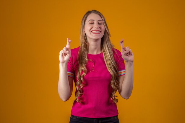 Young woman with crossed fingers. Luck