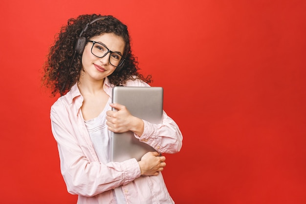 Young woman with curly brunet hair with laptop