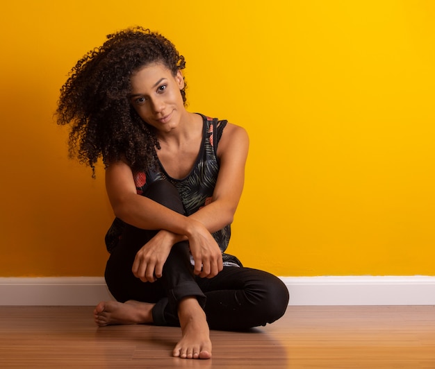 Young woman with curly hair on the floor