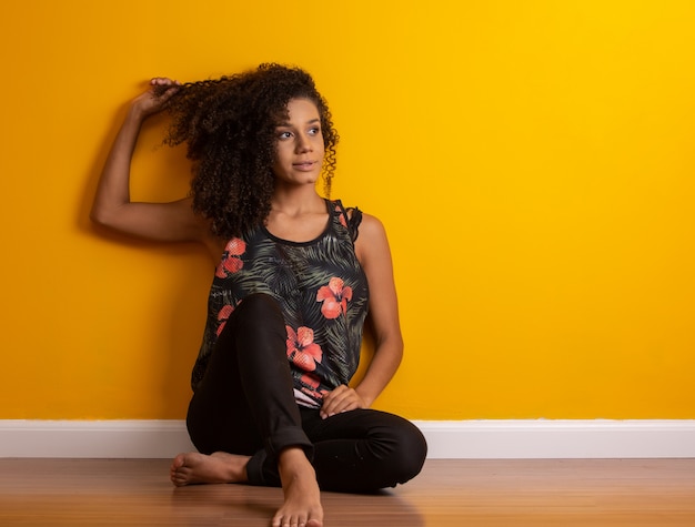 Young woman with curly hair on the floor