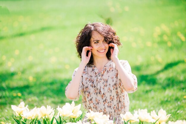 Young woman with curly hair in the park