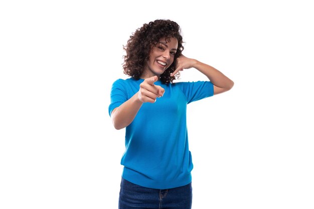 A young woman with a curly hairstyle above her shoulders feels joy