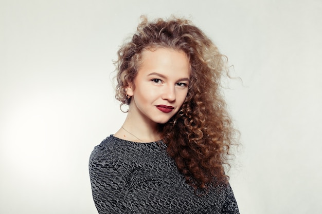 Young woman with curly long hair