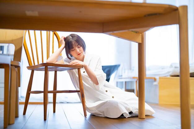 A young woman with a depressed look in the room