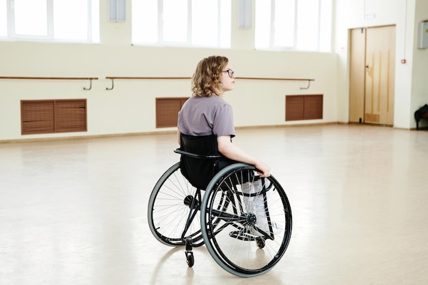 Young woman with disability alone in dance studio