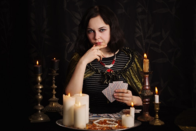 Young woman with divination cards in room