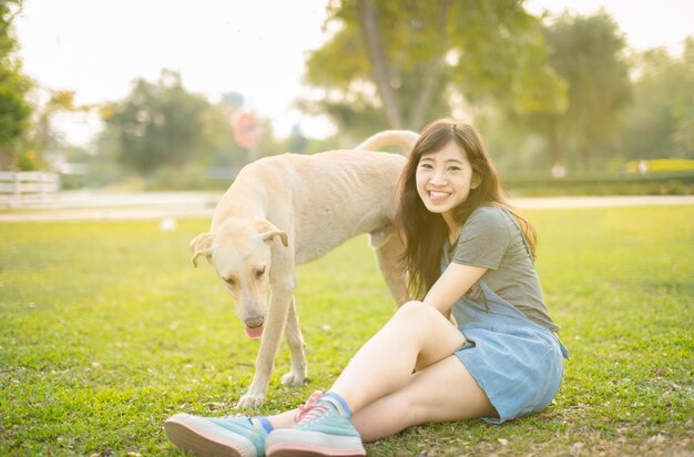 Young woman with dog on the grass