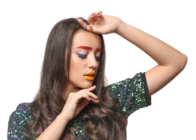 Young woman with dyed eyebrows and creative makeup on white