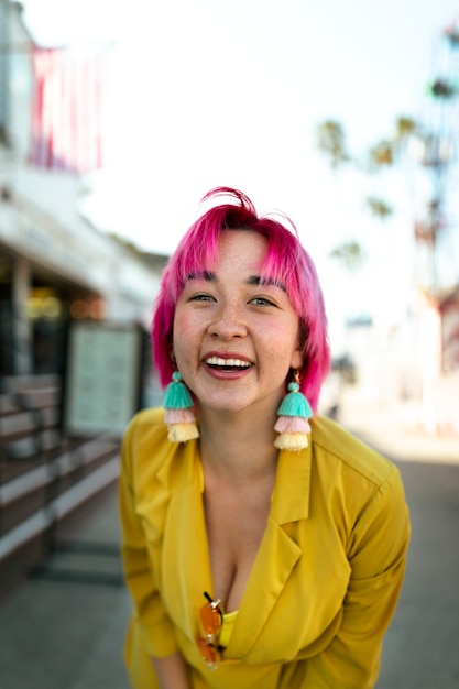 Young woman with dyed hair near shop