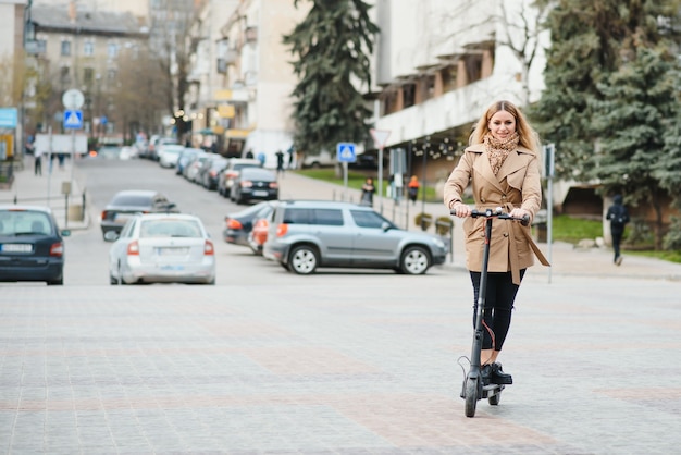 Young woman with electric scooter in the city