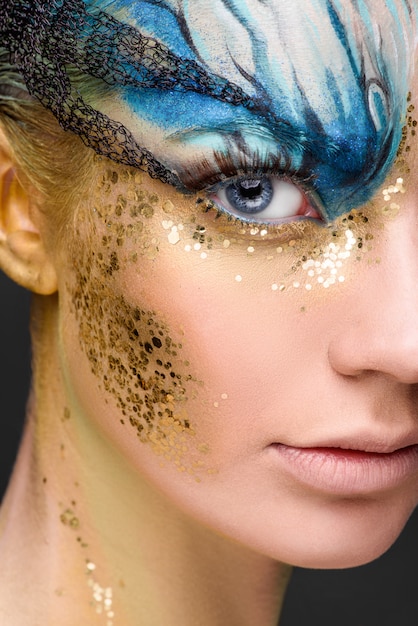 Young woman with fantasy make up. Close up