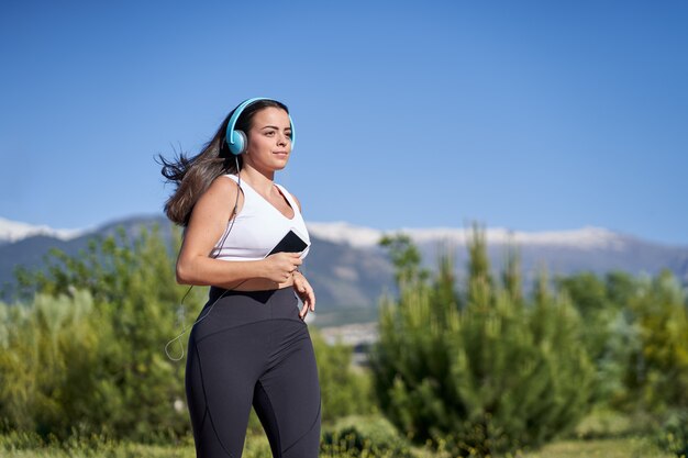 Young woman with fit body running. Female model