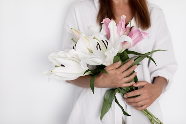 Young woman with flower lily indoor