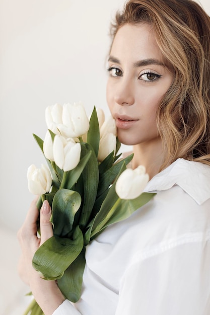 Young woman with flowers tulips