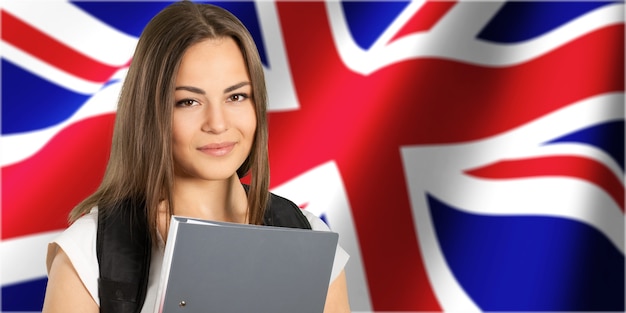 Young woman with folder on british flag background