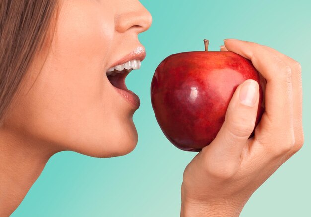 Young woman with fresh red apple