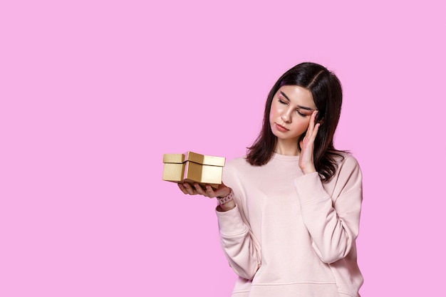 A young woman with a gift box in her hands