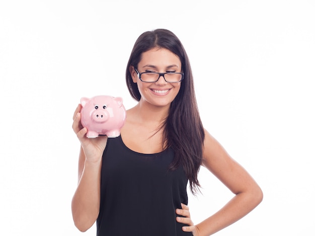 Young woman with glasses happy with piggy bank