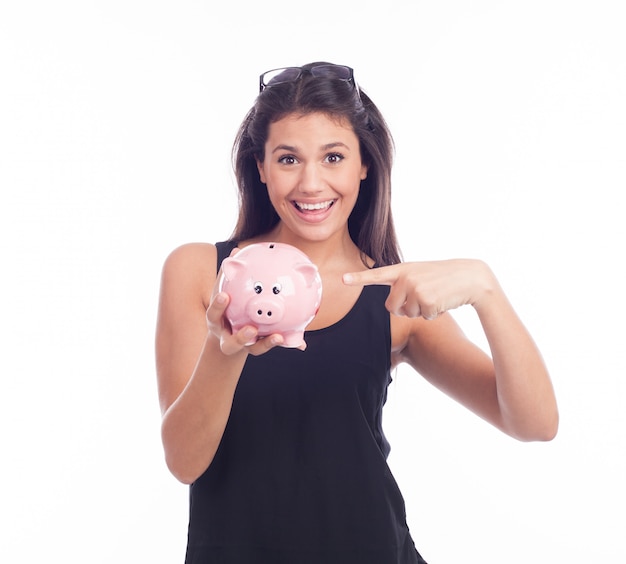 Young woman with glasses happy with piggy bank