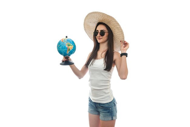 Young woman with globe in hat isolated on white