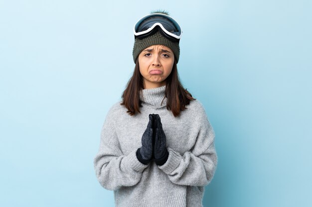 Young woman with goggles and winter clothes