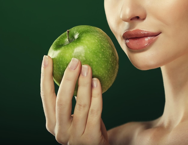 녹색 배경 위에 녹색 사과와 젊은 여자