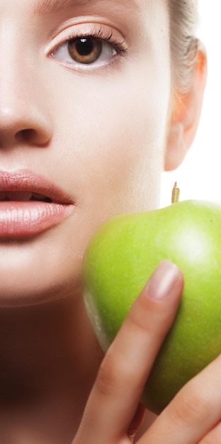 Young woman with green apple isolated on white background