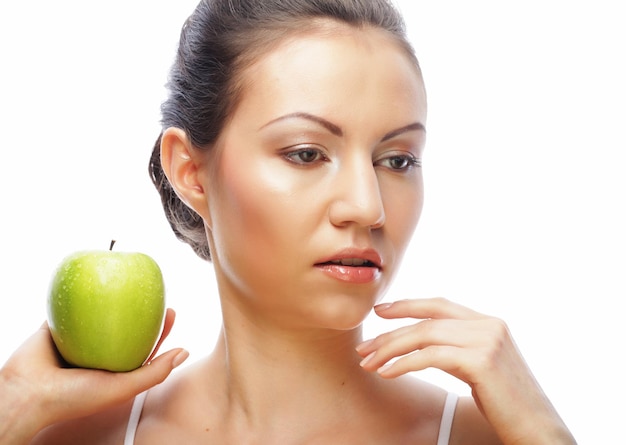 Young woman with green apple isolated on white background