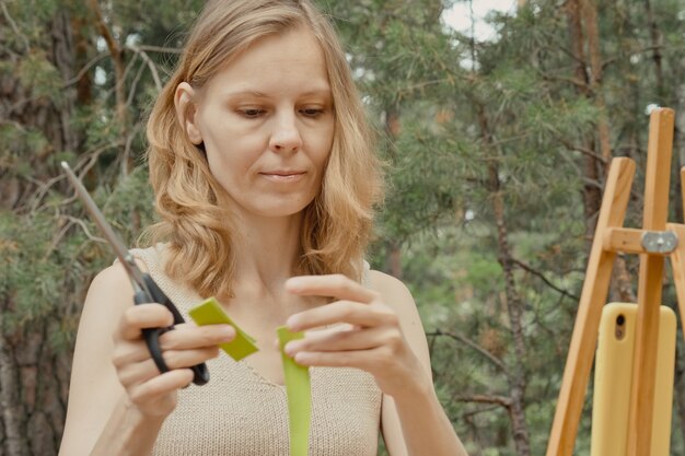 Young woman with green tapes on face Face aesthetic taping