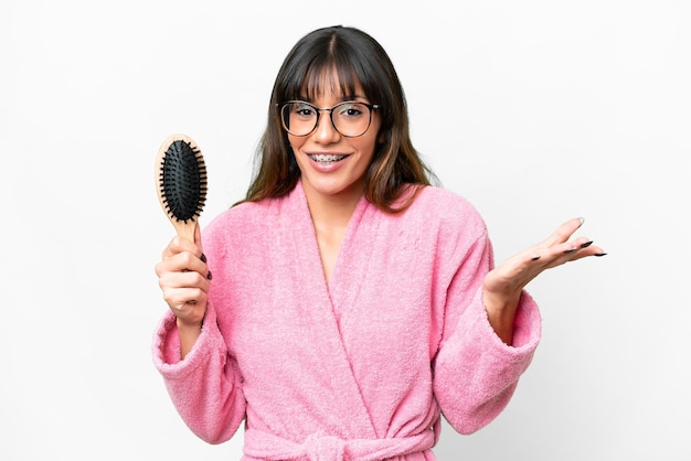 Photo young woman with hair comb over isolated white background with shocked facial expression