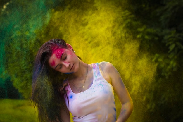 Young woman with hair motion and dry powder around her