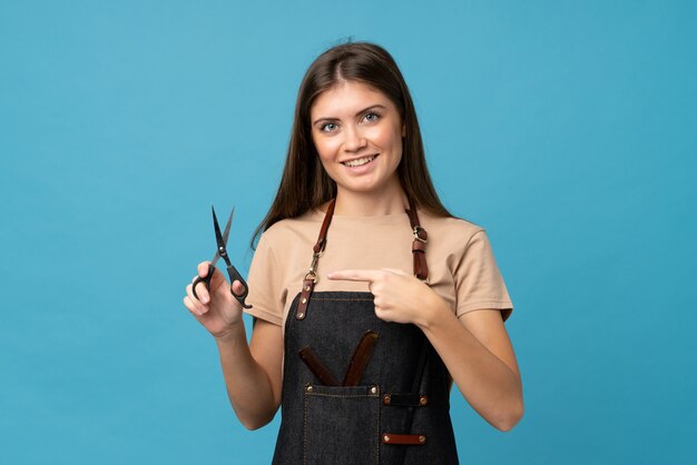 Young woman with hairdresser or barber dress and pointing it