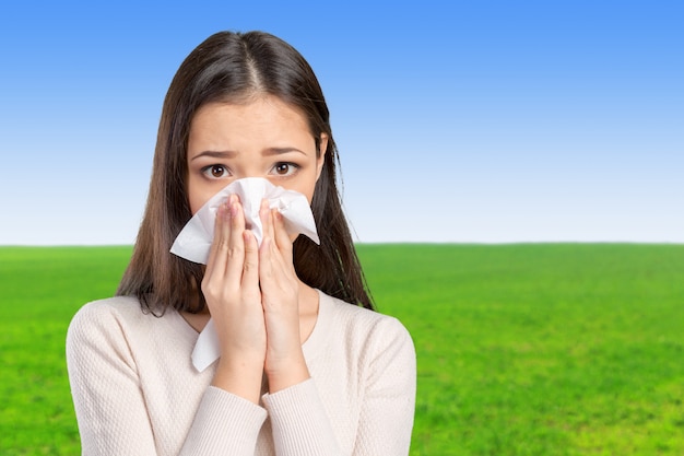 Young woman with handkerchief having cold