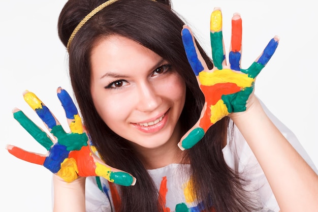 Young woman with hands painted with colorful paints ready for handprints