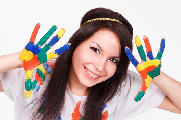 Young woman with hands painted with colorful paints ready for handprints