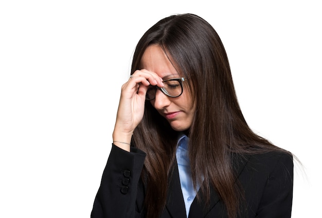 A young woman with a headache holding head, isolated on white background