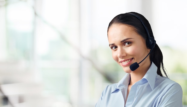 Young woman  with headphones, call center or support concept