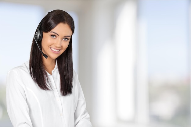 Young woman  with headphones, call center or support concept