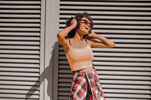 A young woman with headphones looking enjoyed and feeling good